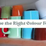 Coloured mugs and cups on a kitchen shelf